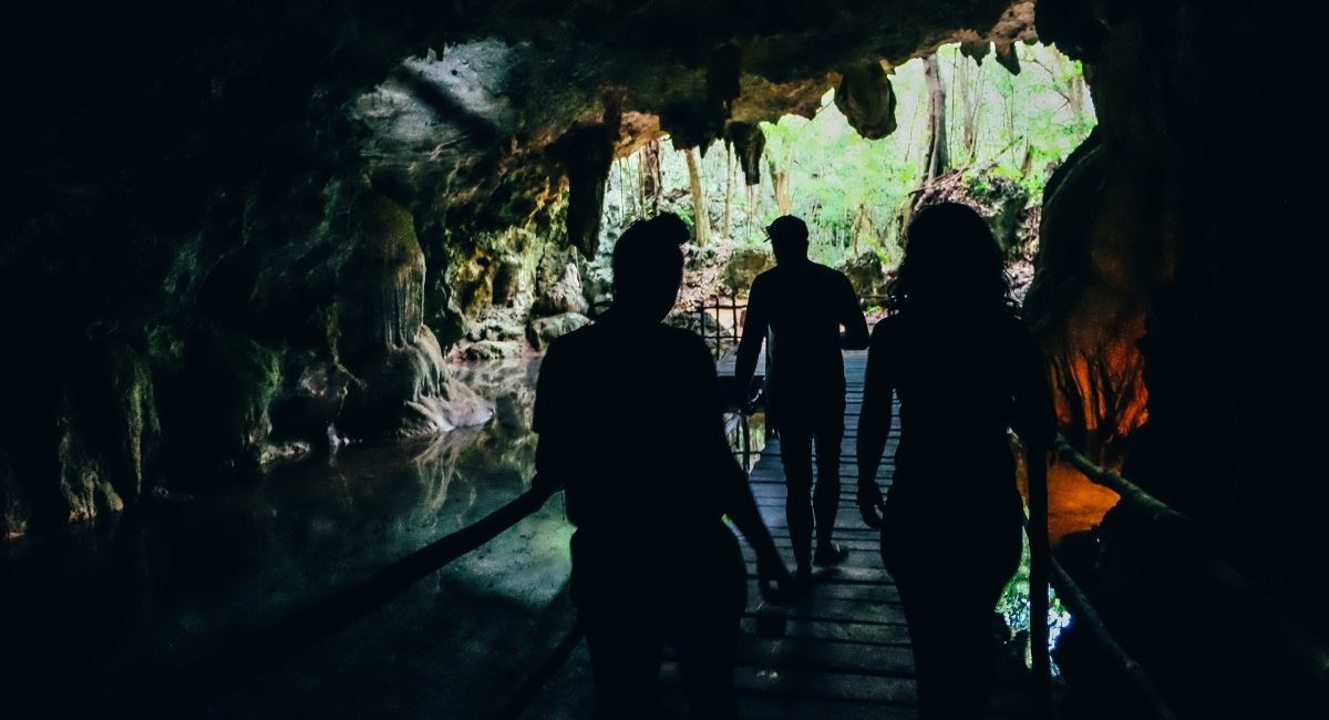 Visitors walking between cave entrances at Crystal Caves Grand Cayman