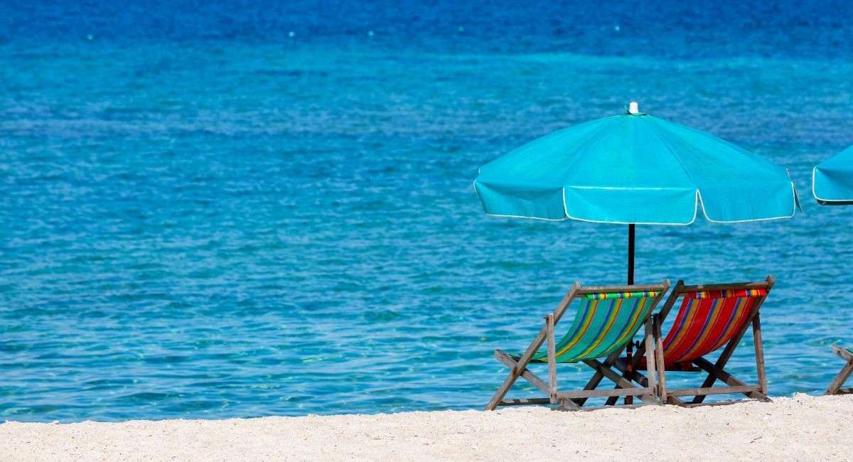 A pair of beach chairs and an umbrella at the quiet eastern end of Cayman Kai Public Beach