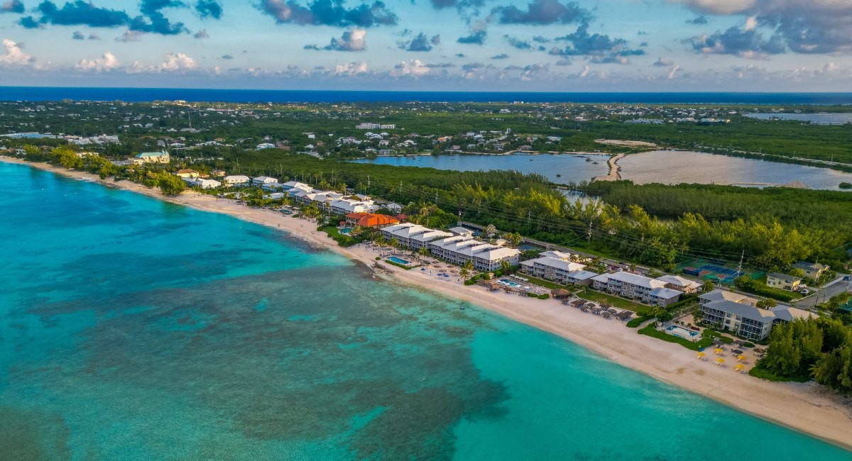 Aerial view of Seven Mile Beach, Grand Cayman, with beachfront condos, turquoise water and the reef